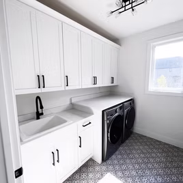 The New Shaker Laundry Room from Lafata Cabinets uses maple wood with a white finish. Cabinets crafted in Michigan since 1958.