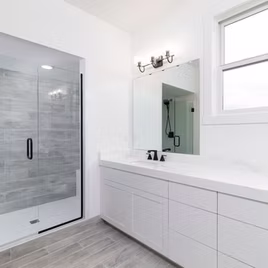 The New Shaker bathroom from Lafata Cabinets uses maple wood with a white finish. Cabinets crafted in Michigan since 1958.