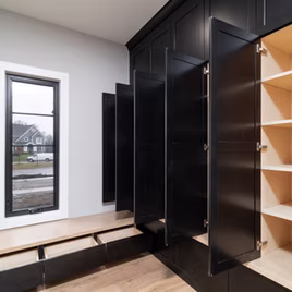 The Brookhaven II Mudroom from Lafata Cabinets uses maple wood with a black paint. Cabinets crafted in Michigan since 1958.